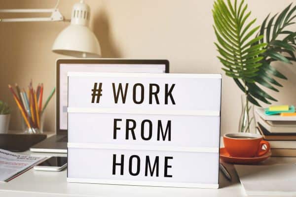 Work from home sign in front of a laptop
