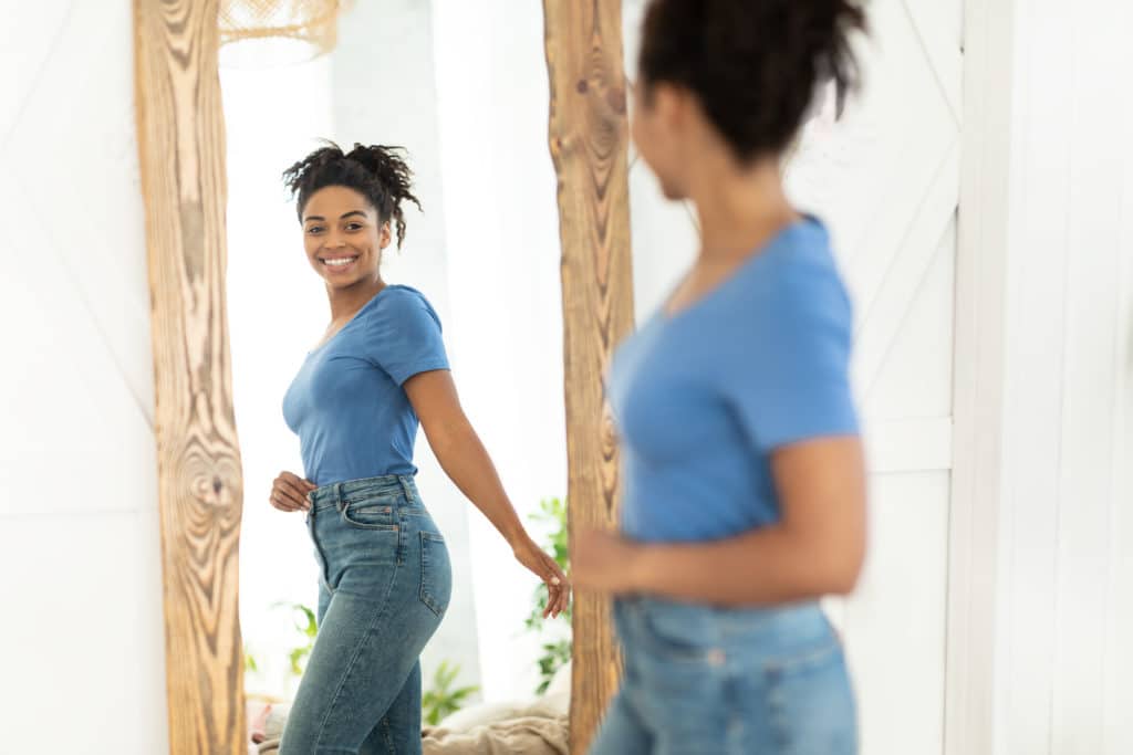 Joyful Girl After Slimming Looking In Mirror