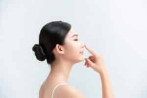 Side,Profile,Of,Asian,Lady,Pointing,Her,Nose