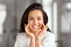 Woman smiling, happy with the results of her composite facelift