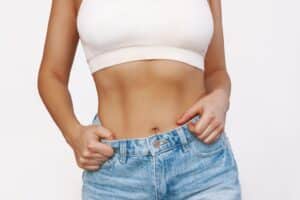 Close up of woman’s slim, toned midsection from tummy tuck surgery