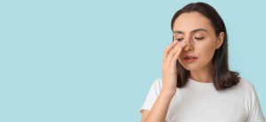 Woman touching her nose after rhinoplasty